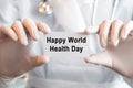 Doctor holding a card with text Happy World Health Day