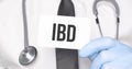 Doctor holding a card with text ibd,medical concept