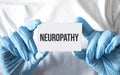 Doctor holding a card with text Neuropathy, medical concept