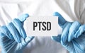 Doctor holding a card with text ptsd, medical concept