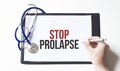 Doctor holding a card with text STOP PROLAPSE, medical concept