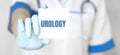 Doctor holding a card with text UROLOGY,medical concept