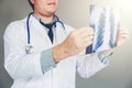 Doctor holding and checking chest x-ray film or roentgen image in ward hospital