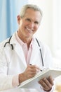 Doctor Holding Clipboard In Clinic Royalty Free Stock Photo