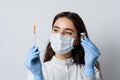 Doctor holding coronavirus vaccine. Covid-19 Vaccination. Stop quarantine. Attractive girl in medical gloves with Royalty Free Stock Photo