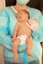 Doctor holding cute newborn child