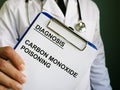 Doctor holds diagnosis Carbon monoxide poisoning Royalty Free Stock Photo