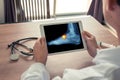 Doctor holding a digital tablet with x-ray of foot and pain on the top