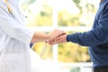 Doctor holding elderly patient hand in hospital Royalty Free Stock Photo