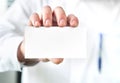 Doctor holding empty white business card
