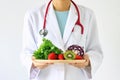 Doctor holding fresh fruit and vegetable, Healthy diet.