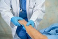 Doctor holding hand and checking Asian senior or elderly old lady woman patient wearing a face mask in hospital for protect Royalty Free Stock Photo