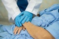 Doctor holding hand and checking Asian senior or elderly old lady woman patient wearing a face mask in hospital for protect Royalty Free Stock Photo