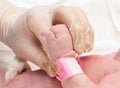Doctor holding the hand of a newborn Royalty Free Stock Photo
