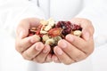 Doctor holding handful of Chinese herbal medicine.