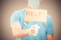 A doctor holding a help sign isolated Royalty Free Stock Photo