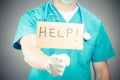 A doctor holding a help sign isolated Royalty Free Stock Photo