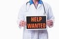 A doctor holding a help wanted sign Royalty Free Stock Photo