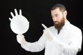 Doctor holding inflated glove.