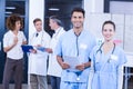 Doctor holding medical report and smiling at camera Royalty Free Stock Photo