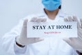Doctor holding the message, Stay at home, stop covid-19