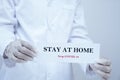 Doctor holding the message, Stay at home, stop covid-19