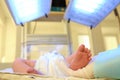 Doctor holding newborn child`s foot in hospital