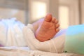 Doctor holding newborn child`s foot in hospital