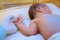 Doctor holding newborn child`s hand in hospital