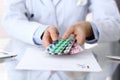 Doctor holding pack of different tablet blisters closeup. Life save service, legal drug store, prescribe medication Royalty Free Stock Photo