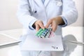 Doctor holding pack of different tablet blisters closeup. Life save service, legal drug store, prescribe medication Royalty Free Stock Photo