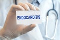 Doctor holding a paper card with text ENDOCARDITIS, medical concept