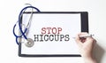 Doctor holding a paper plate with text STOP HICCUPS, medical concept