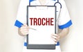 Doctor holding a paper plate with text TROCHE, medical concept Royalty Free Stock Photo