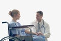 Doctor holding patient's hand who setting on wheelchair doctor cheer up patient to make her feel reassured and