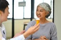 Doctor holding pills bottles, explaining, discussing medical checkup result with mature patient Royalty Free Stock Photo