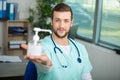 Doctor holding pump dispenser antibacterial handwash Royalty Free Stock Photo