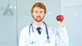 Doctor Holding Red Apple to Express Healthy Lifestyle Royalty Free Stock Photo