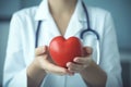 Doctor holding red heart in hands. Generative AI Royalty Free Stock Photo