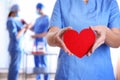Doctor holding red heart at hospital, closeup Royalty Free Stock Photo