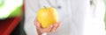 Doctor holding ripe yellow apple in hand Royalty Free Stock Photo