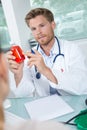 doctor holding and showing medicine bottle