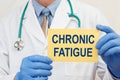 Doctor holding sign with text CHRONIC FATIGUE Royalty Free Stock Photo