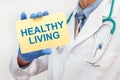 Doctor holding sign with text HALTHY LIVING closeup