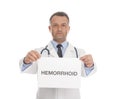 Doctor holding sign with word HEMORRHOID Royalty Free Stock Photo