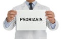 Doctor holding sign with word PSORIASIS on white, closeup Royalty Free Stock Photo