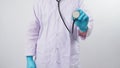 Doctor is holding stethoscope in hand with wearing blue latex gloves on white background Royalty Free Stock Photo