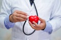 Doctor holding stethoscope and red heart in his hand in nursing hospital ward Royalty Free Stock Photo