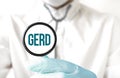 Doctor holding a stethoscope with text GERD, medical concept Royalty Free Stock Photo