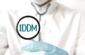 Doctor holding a stethoscope with text IDDM, medical concept Royalty Free Stock Photo